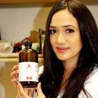 Photo of a woman hold a bottle of CBD tincture